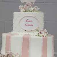 Alexis Victoria First Communion cake for my friend's daughter. Buttercream icing with mmf stripes, gumpaste cross & flowers. Original design...