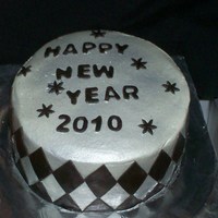 Black And Silver New Years Cake 8" white round cakes w/ buttercream icing airbrushed silver sheen. black fondant accents.