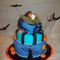 Halloween Celebration This fondant cake was a 3 tier yellow cake with vanilla BC filling and dreamsicle icing. It was for a friends annual Halloween party.