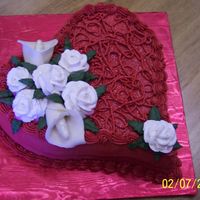 Kelli_Bd_Cake_2~0.jpg I Used a Wilton Heart Shapd pan. Decorated with wilton red red color.Buttercream icing with fresh strawberry/cream cheese filling. Roses...