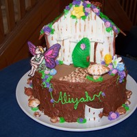 Fairy House The house and "stump" are cake with BC. The decorations are a combination of fondant (the bark on the house, the door, the...