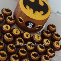 Batman Birthday Cake 'n' Cupcakes Created for my nephew. Batman symbol was cut-out individually using various shaped cutters...very time consuming.