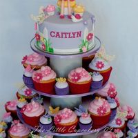 Fairy Birthday Cupcake Tower Created for a 7th birthday party. All decorations are handmade from fondant. Cakes are a mixture of white choc mud cake and dark choc mud...