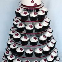 Aubergine Wedding Cupcake Tower Created for a horse themed wedding. Groom proposed at the races and so the reception is also at the races. I created bride and groom...