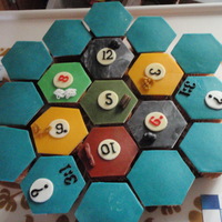 Catan cupcakes filled with cassiscreme (blue tiles) and rasberrycreme (other tiles).