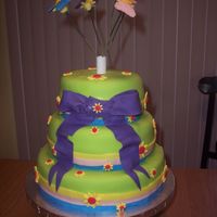 Butterflies And Daisies Fondant covered cake with daisies and butterflies.