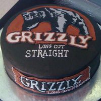 Can Of Snuff Grizzly bear is painted fondant cut out. Word Grizzly on top is FBCT. Everything else is buttercream.