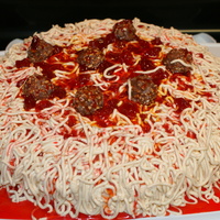 Spaghetti And Meatballs 12" round single layer cake. Buttercream piped for noodles, strawberry topping for sauce, and chocolate truffles for the meatballs