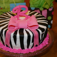 Zebra And Pink Bow buttercream with fondant zebra stripes. Gumpaste bow and letter B. Had a little crack in the B. Still getting the hang of fondant and...