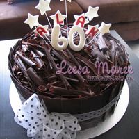 Death By Chocolate - Black Forest Cake 12 Inches of chocolate sponge, torted with sour cherry filling and cream, covered in chocolate panels and curls.Used a kilo of chocolate on...