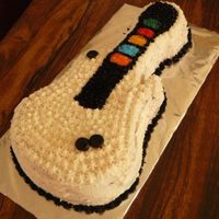 Guitar Hero Cake I made this birthday cake for my brother who loves video games and Guitar Hero.Wilton Guitar Cake Pan, Buttercream icing and colored sugar...
