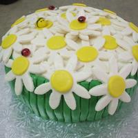 Flowers I saw SunshineSally's daisy cake and loved it. My inexperience combined with the wrong cutter resulted in a cake that pales by...