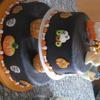 Halloween Pumpkin Cake The tops pieces are chocolate suckers. This cake is covered in fondant.