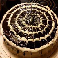 Spider Web Cake Chocolate chip pumpkin cake with cream cheese icing and chocolate glaze.