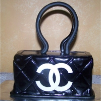 Black Coco Channel Purse Cake This was done as a sample cake for a meeting. It was yellow cake with dreamcycle filling.