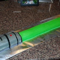 Lightsaber Cake Chocolate cake (cut from 9x13 pan) shaped into lightsaber. All BC decorations (with the exception of the red "gobstopper" for the...