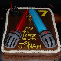 Dueling Light Saber Cake My 7 year old wanted two light sabers fighting. 11x15 cake (1/2 choc/1/2 yellow), chocolate buttercream, lightsabers formed with brownie...