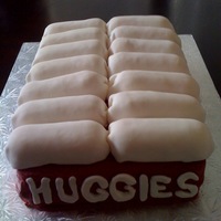 Huggies Diaper Box 9x13 cakes, covered in buttercream. Fondant "Huggies" letters, diapers are Twinkies wrapped in fondant.