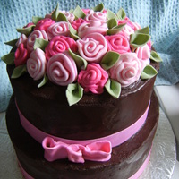 Rose Cake french vanilla cake with buttercream filling and chocolate ganache covering it fondant ribbon roses and fondant leaves! the first time...