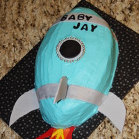 Rocket Ship Buttercream with fondant accents and gumpaste tail fins.
