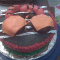 Father's Day Grill Cake Bakes the cake in a bowl and carved the center. added marshmallows painted black and dusted with confec. sugar for charcoal. used bc icing...