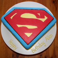 Superman Logo White Chocolate mud cake covered with buttercream and fondant.