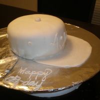 Baseball Cap cake covered in white fondant, baseball hat style for older boys birthday