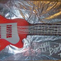 Guitar Cake I made this for my sons birthday it was a white cake with buttercream frosting and chocolate bavarian cream filling YUM!! I used the wilton...