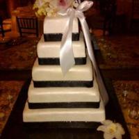 Shimmering Wedding Cake This cake was for my friends wedding. White fondant covered with pearl iridscent spray. The black is satin ribbon with a hand sewn jewel...