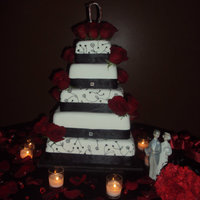 Classic Style This cake was for a friends wedding. It ended up being 5 tiers. I alternated detailed tiers with white tiers. All tiers had black satin...