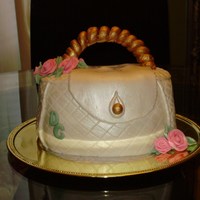 Purse Cake Flowers made from Gumpaste, cake covered in fondant. My first attempt at making a purse cake.
