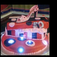 High Heel Shoe Cake Cake covered in mmf. Shoe is made of gumpaste. Base cake has led lights.