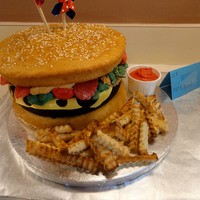 Cheeseburger And Fries Cake Yellow cake for the hamburger bun, a brownie for the hamburger patty, and poundcake for the fries.