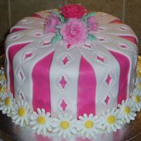 Birthday Cake White cake with almond flavored buttercream icing...covered and decorated with fondant and royal icing daisies.