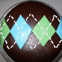 Chocolate Argyle chocolate cake covered in chocolate MMF for my father in law's birthday. Diamonds are MMF and white stitching is buttercream icing.