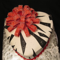 Zebra Print Heart strawberry margarits cake with lime buttercream filling. Fondant zebra stripes and red loopy bow encrusted with sanding sugar