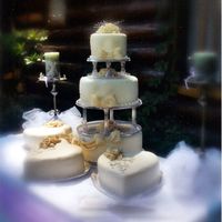 Here's My Heart The center round tiers are adorned with hand-rolled ribbon roses, luxuriant fondant swags and bows. Decorated with tone on tone swirl...