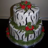Zebra Print And Red Roses Zebra painted fondant with red ribbon roses.