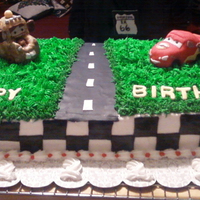 Cars Cake figures made with rk covered in mmf, cake 1/2 white, 1/2 chocolate, bc and mmf accents,