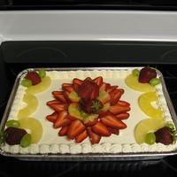 Tres Leche Tres Leche cake with whipped topping and fresh fruit