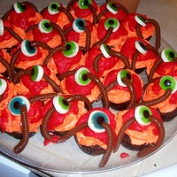 Bloody Eyeball Cupcakes I made these for my 5th grade son's class this year. The eyes and worms are gummy candy from Oriental Trading Co. I melted the red...