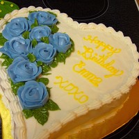 Mil's 60Th Lemon cake with raspberry filling covered in buttercream with bc roses.
