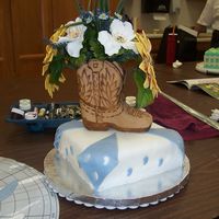 003.jpg cowboy boot made out of rice crispy then covered with fondant w/fondant flowers.