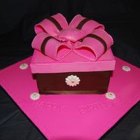 Pink & Chocolate Box Cake Chocolate cake with Chocolate buttercream and Raspberry Buttercream, covered by Chocolate Fondant. White Chocolate Daisy with Pink Luster...