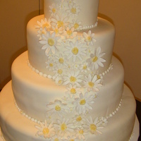 Sweet Daisies Wedding Cake 18,14,10 & 6" tiers of almond and citrus bowl cake with bc and mm fondant. Gumpaste daisies with sparkle centers.