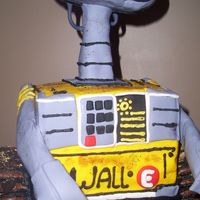 Wall E Cake Rice Krispy head, tires and base (black part). Arms are paper covered with fondant and the yellow square body is all chocolate cake. I used...
