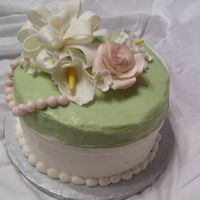 Green And White Cake This is a chocolate cake with cream cheese icing. The bow and flowers are fondant/ gumpaste. Thanks for looking!