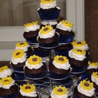 Sunflower Cupcake Tower Vegan and regular chocolate cupcakes with royal icing sunflowers on top.