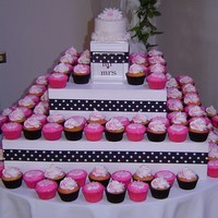 Wedding Cupcake Tower Black cupcake liners have yellow cake with vanilla buttercream frosting swirls and hot pink sugar sprinkled on top. Pink cupcake liners...
