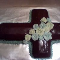 Boy Cross This was done for my godson's baptism the fowers are made from fondant and it is a chocolate cake covered with ganache'